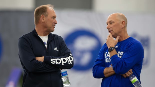 Kansas football coach Lance Leipold (left) talks with recent hire Sean Snyder (right) during Pro Day Friday.